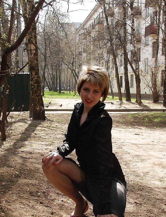 15P Blond teen in stockings shows small tits in street