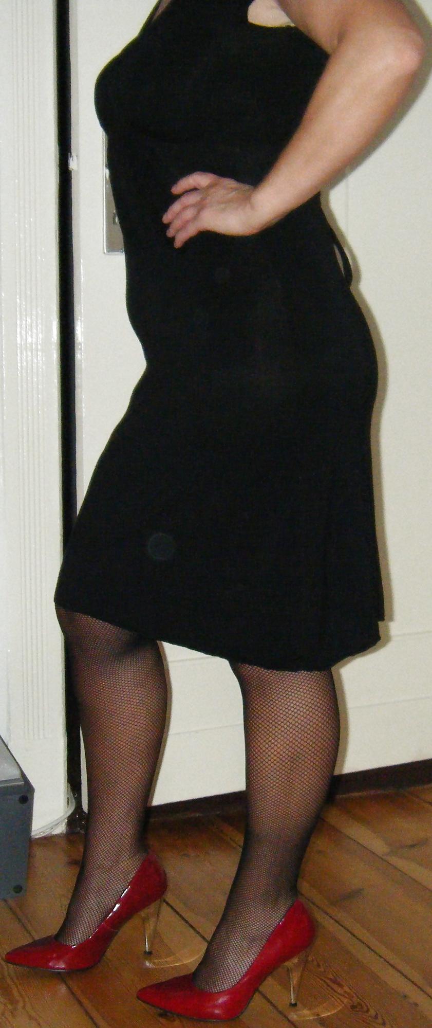 10P Black Fishnet Stockings in Red Highheels and a Shaved Pussy