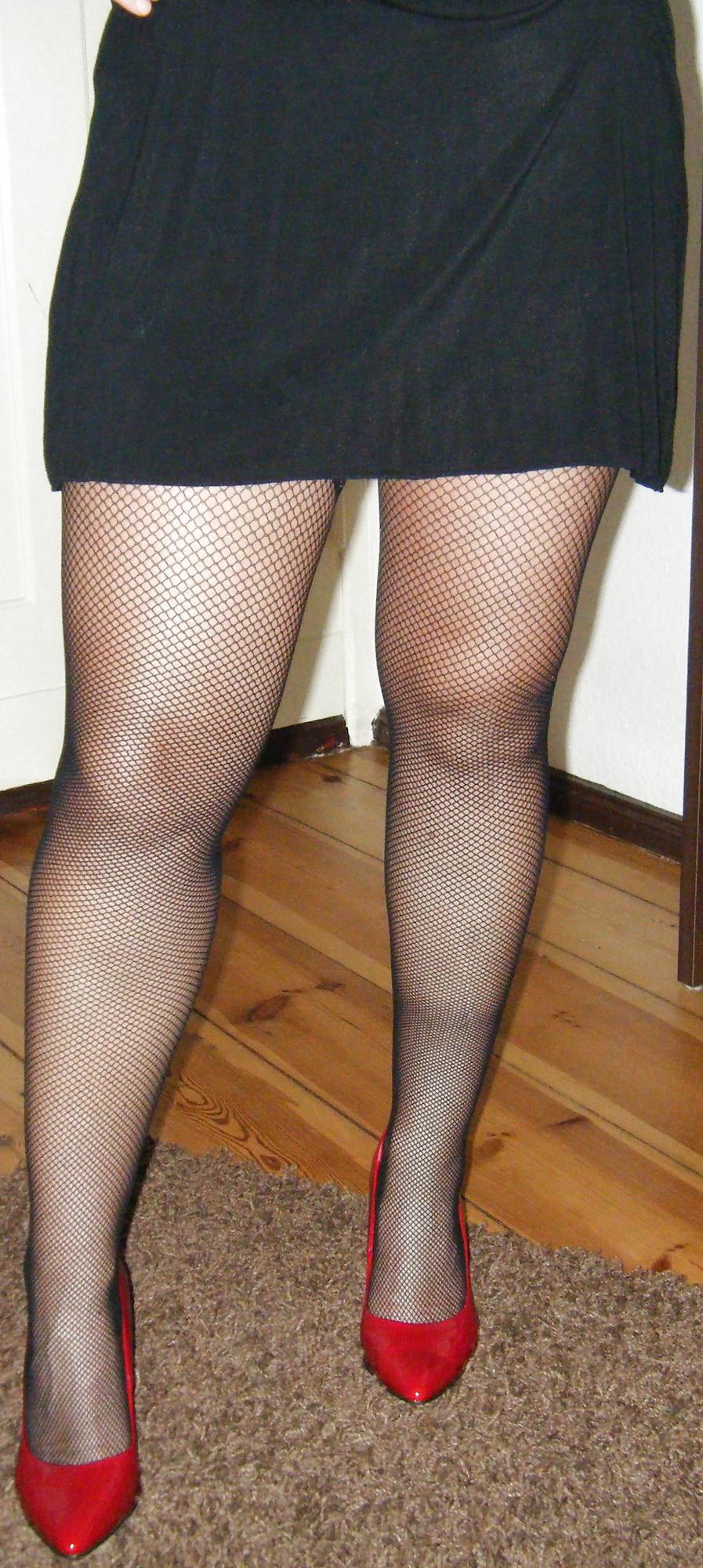 10P Black Fishnet Stockings in Red Highheels and a Shaved Pussy