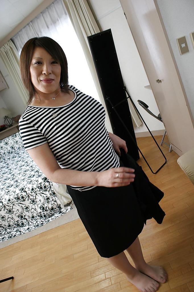 15P Asian MILF in pantyhose Kimiko Ogata stripping off her suit and lingerie top