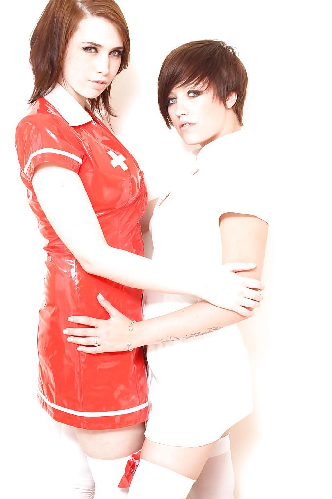 16P Lusty teen babes in nurse uniform and stockings stripping each other