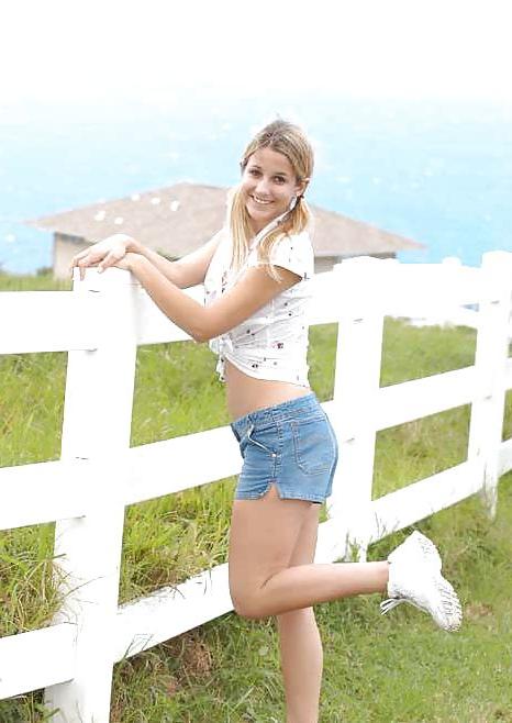 16P Blond teen strips infront of a fence for cows