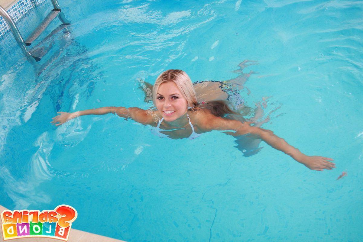 15P Pictures of teen Sabrina Blond riding cock by the pool