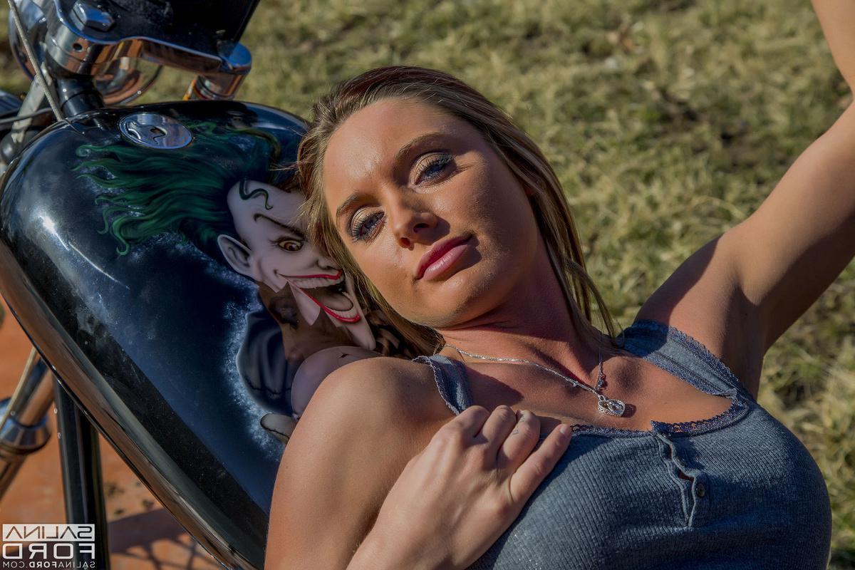 15P Salina Ford hops on a giant chopper and starts stripping