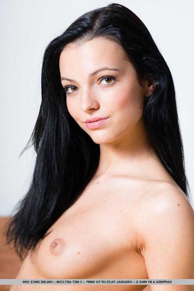 18P Pretty brunette Sapphira A spreads her legs in black stockings