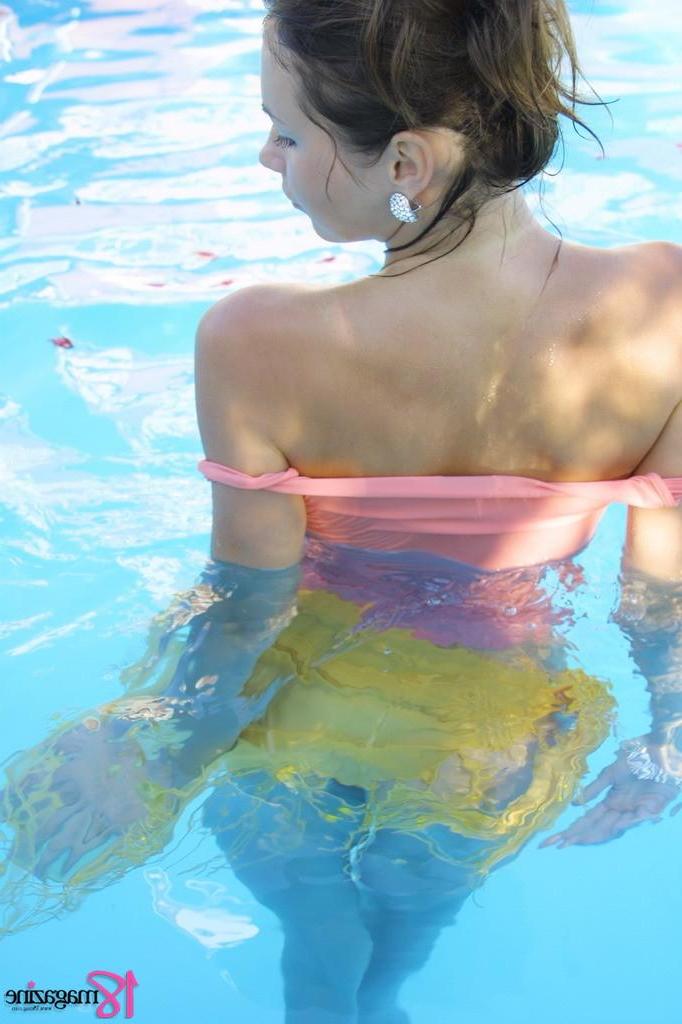15P Busty brunette teen with big boobs gets naked in the pool