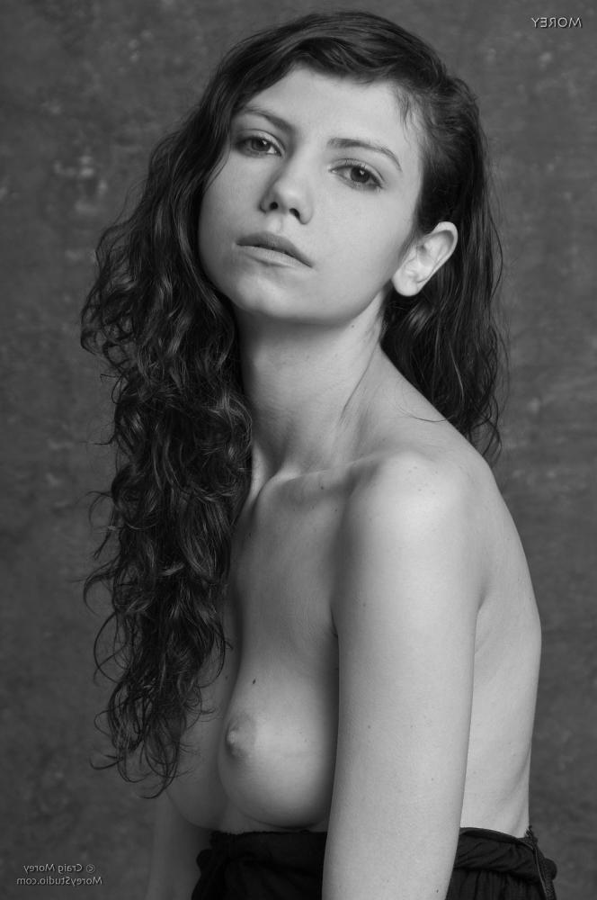 11P Brunette coed Trishi exposes her perky boobs for you in the studio