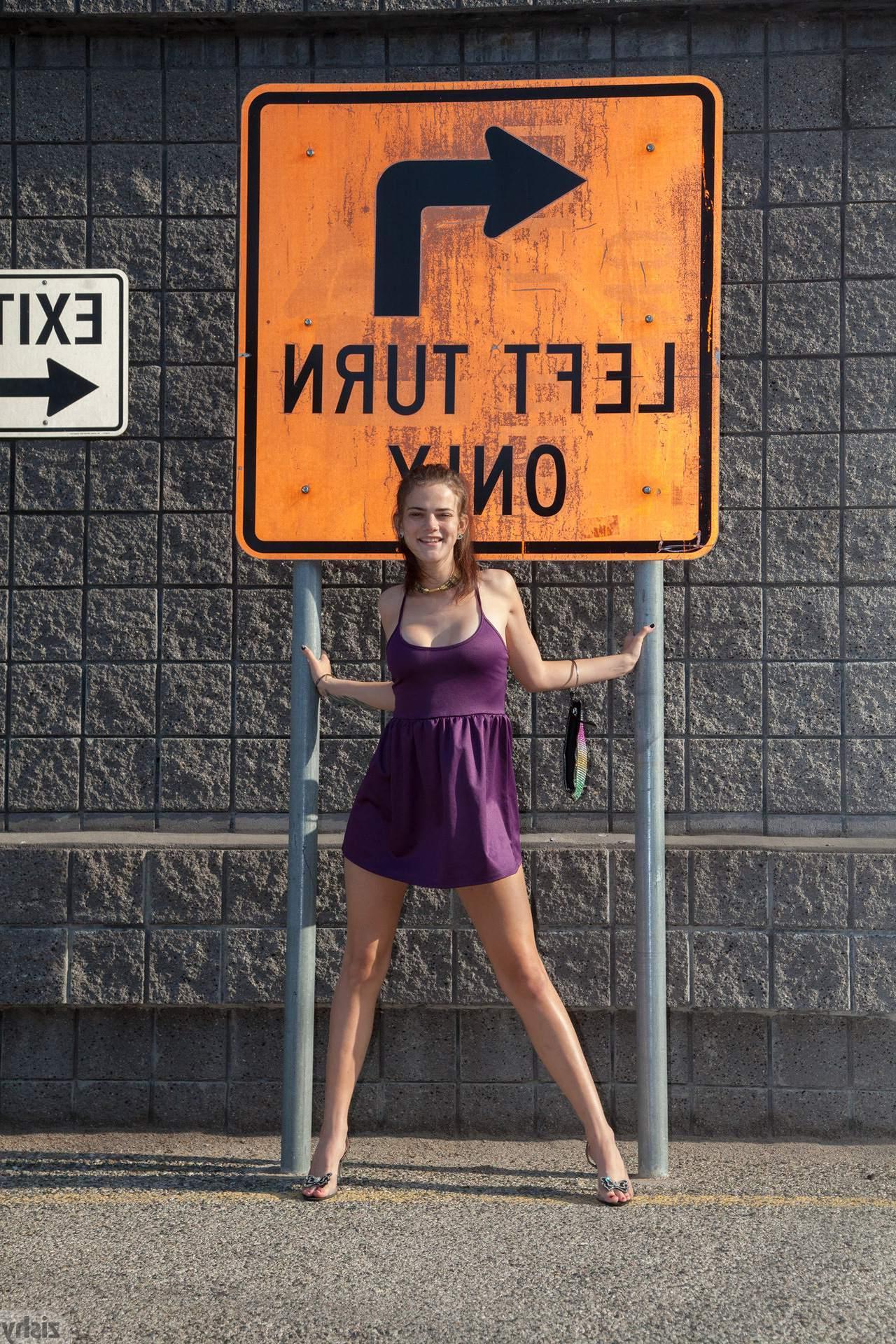 12P Naughty coed Tristan Berrimore shows off her sexy legs in a purple dress