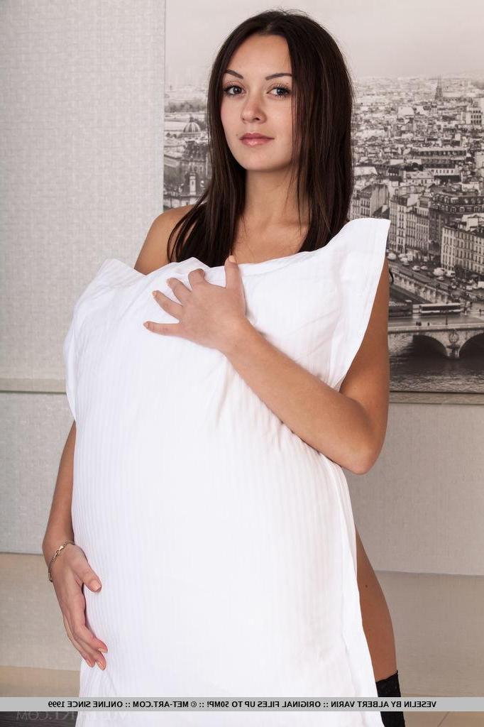 18P Brunette teen Veselin puts on her black stockings and hops into bed in "Fijesa"
