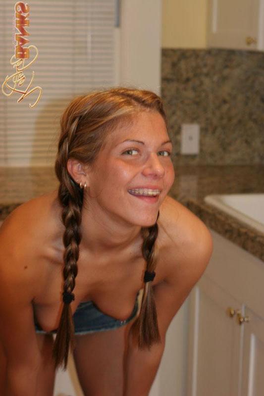 20P Pictures of a hot blond coed in pigtails getting naked