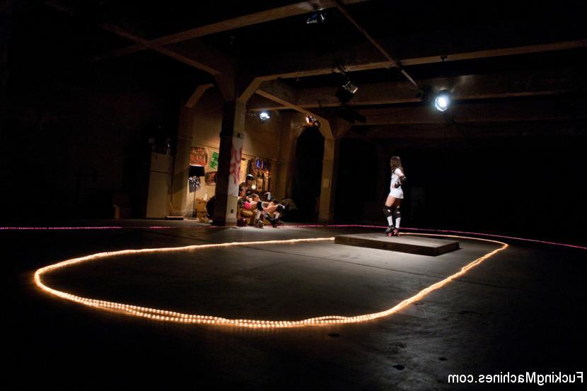 15P In the distance, Angel Dust (Remy LaCroix) stands in the middle of the rink, a s