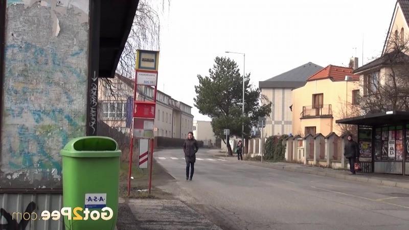 15P Sexy brunette babe pisses behind a bus stop