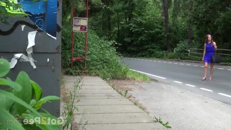 15P Pretty brunette pees next to a bus stop