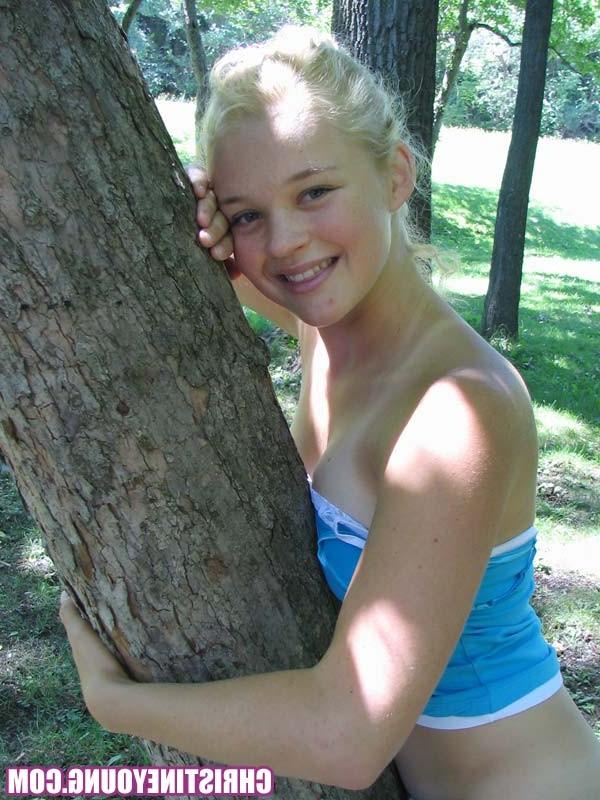 14P Pretty blonde teen girl Christine Young posing in a park