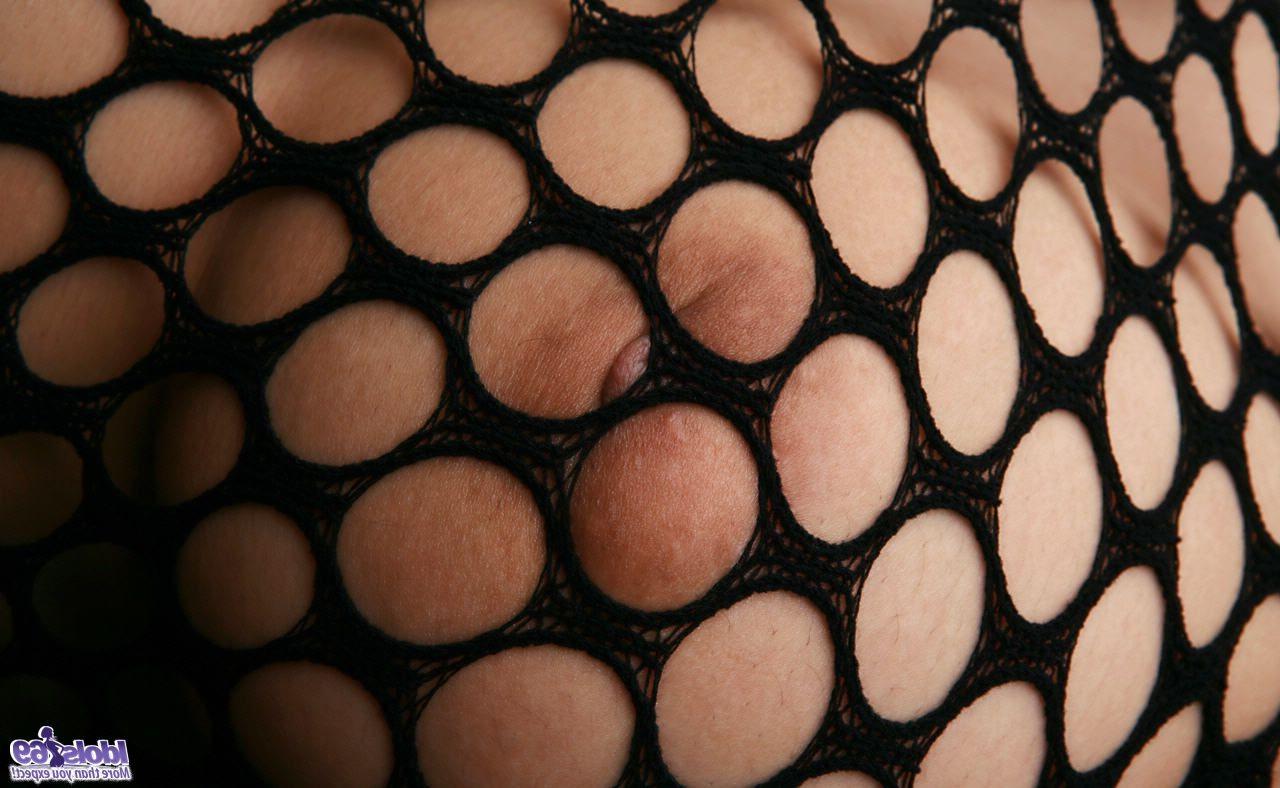 15P A skinny Japanese woman in a fishnet body stocking