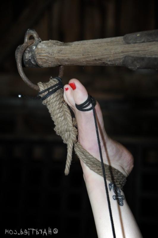 16P Dixon Mason is blindfolded and bound upside down in dark dungeon