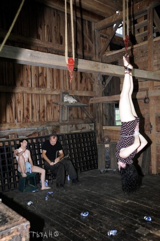 16P Dixon Mason is blindfolded and bound upside down in dark dungeon