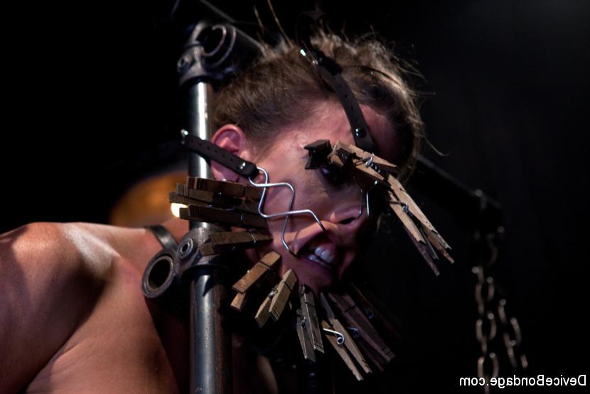 15P Ariel X busty bdsm babe bound in metal her body clamped