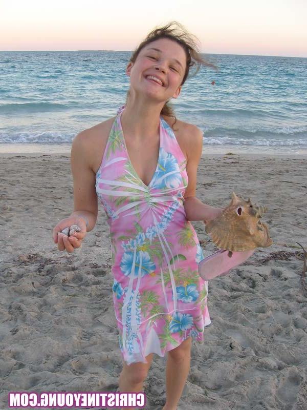 15P Amazing teen Christine Young flashing her tits on the beach