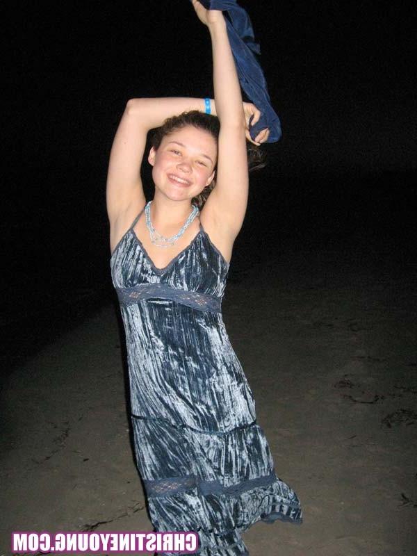 15P Cheerful teen Christine Young poses after dark on the beach