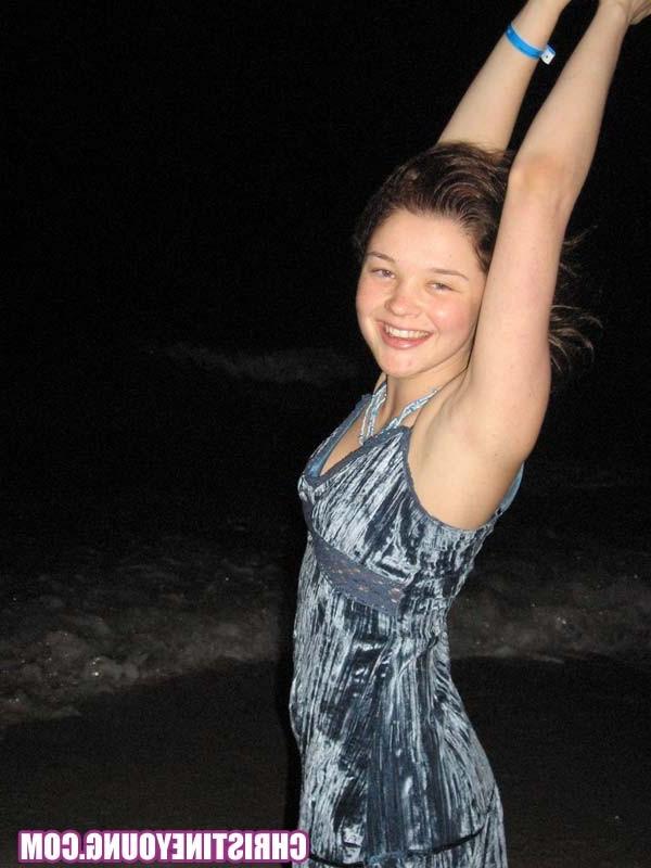 15P Cheerful teen Christine Young poses after dark on the beach