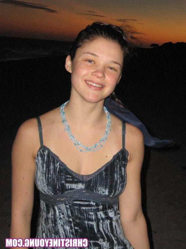 15P Cheerful teen Christine Young poses after dark on the beach