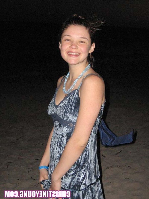 15P Cheerful teen Christine Young poses after dark on the beach
