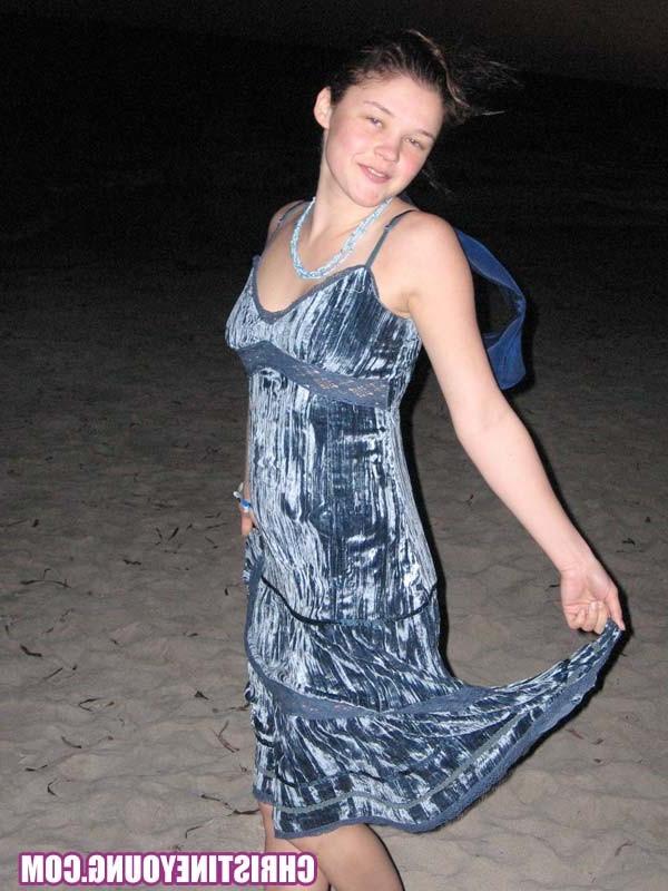 15P Cheerful teen Christine Young poses after dark on the beach