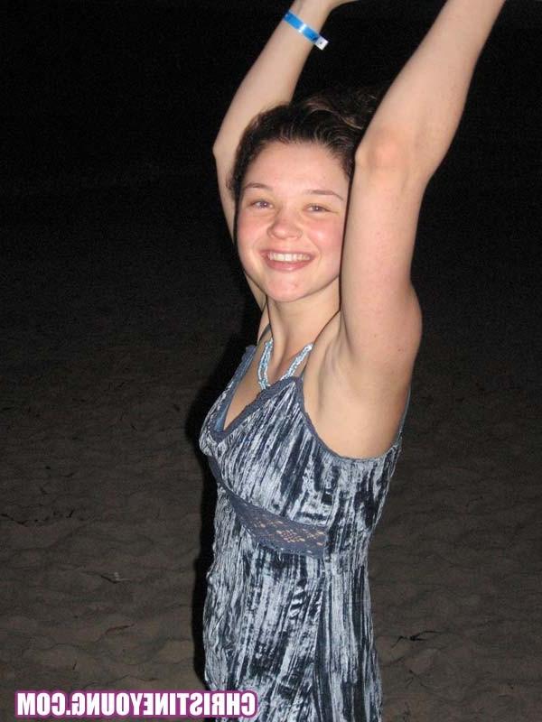 15P Cheerful teen Christine Young poses after dark on the beach