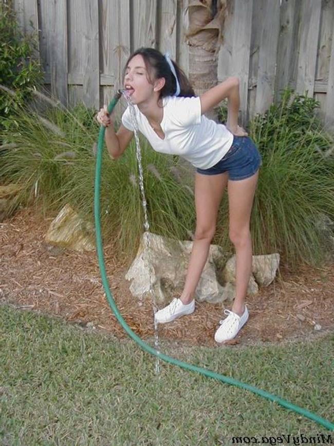 15P Mindy Vega outside in a wet t-shirt