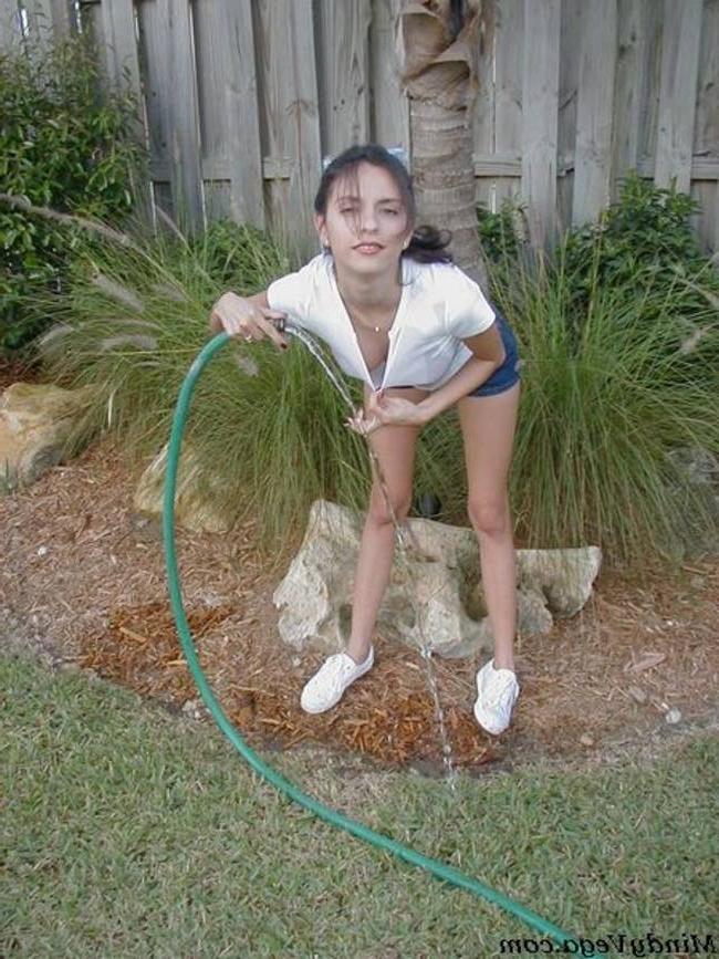 15P Mindy Vega outside in a wet t-shirt