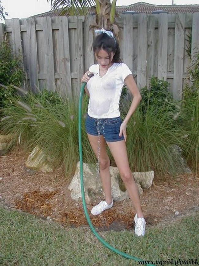 15P Mindy Vega outside in a wet t-shirt