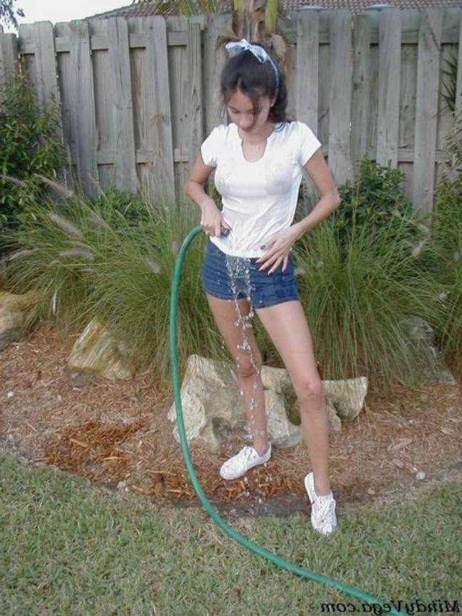 15P Mindy Vega outside in a wet t-shirt