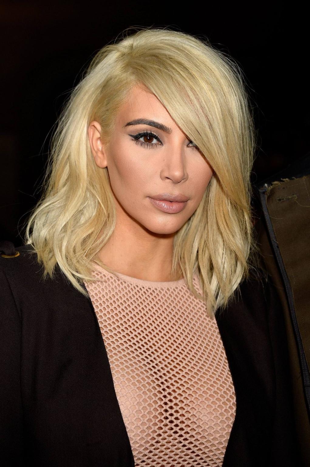16P Kim Kardashian shows off her huge boobs braless in a fishnet dress at the Lanvin