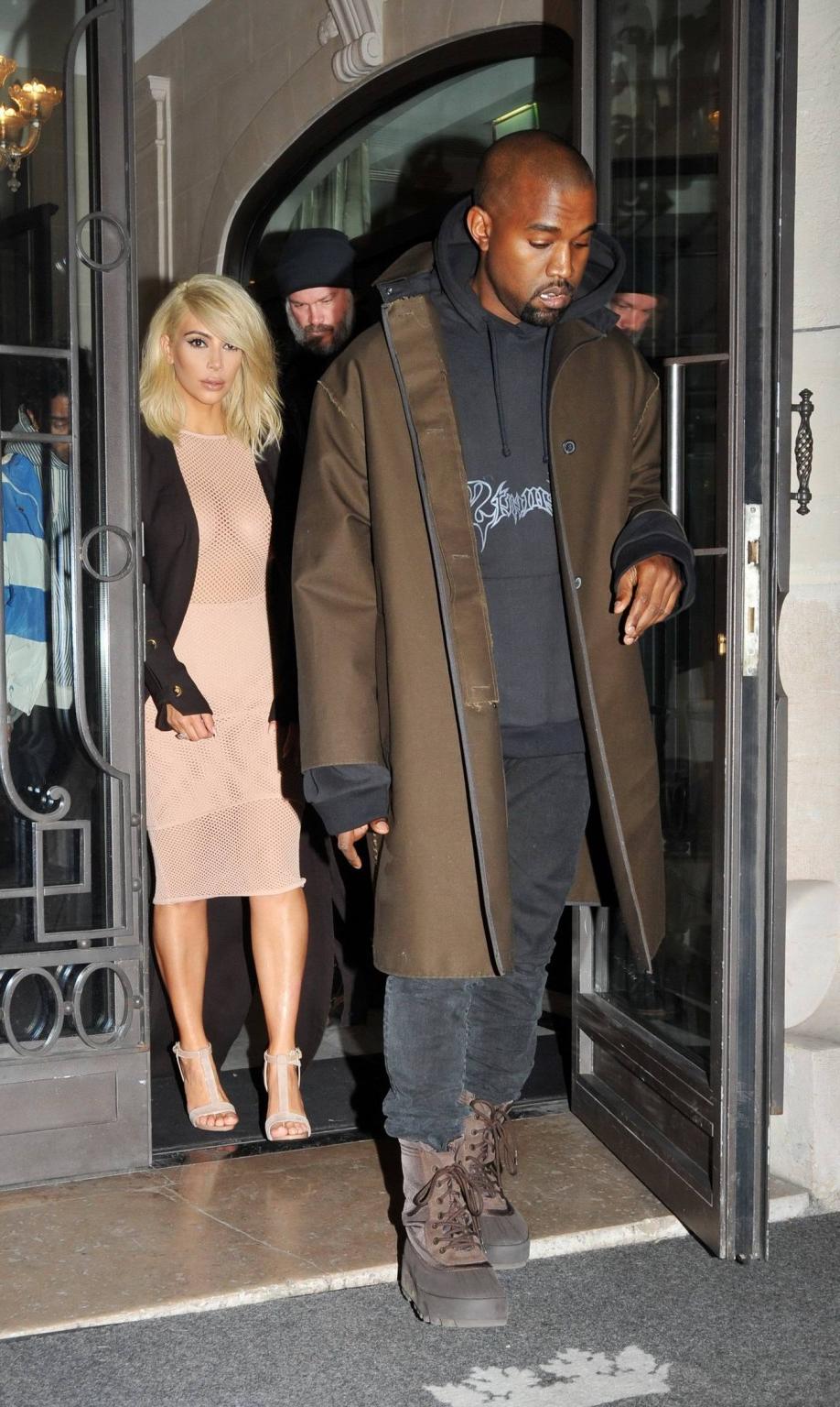 16P Kim Kardashian shows off her huge boobs braless in a fishnet dress at the Lanvin