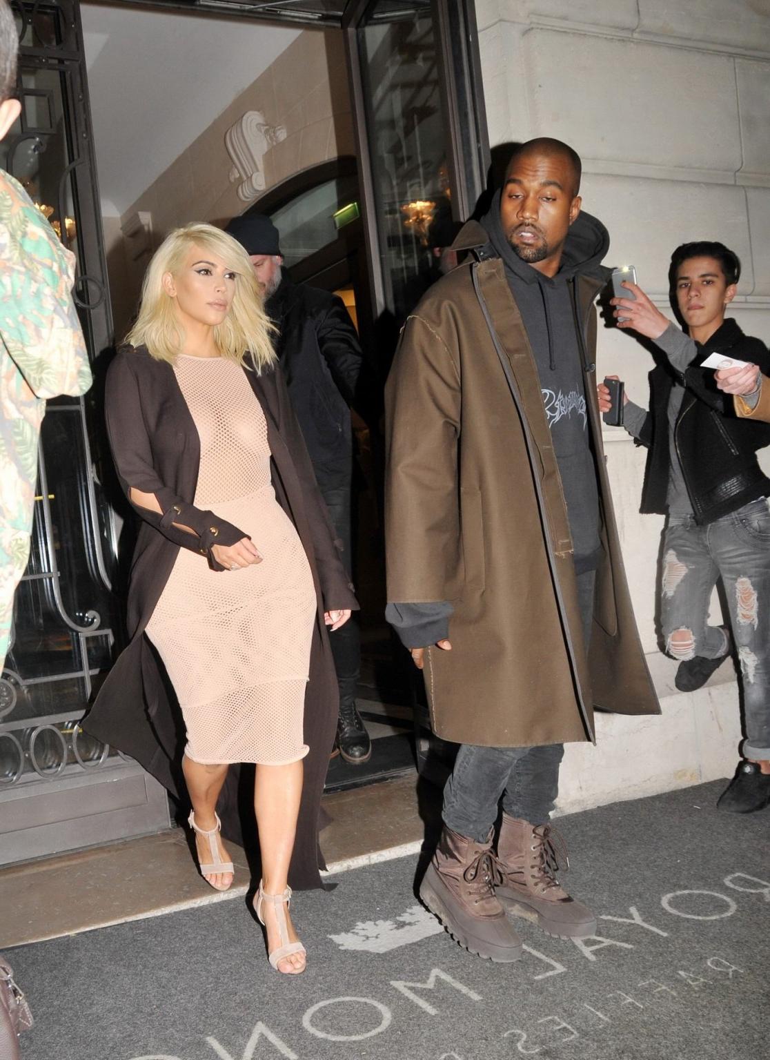 16P Kim Kardashian shows off her huge boobs braless in a fishnet dress at the Lanvin