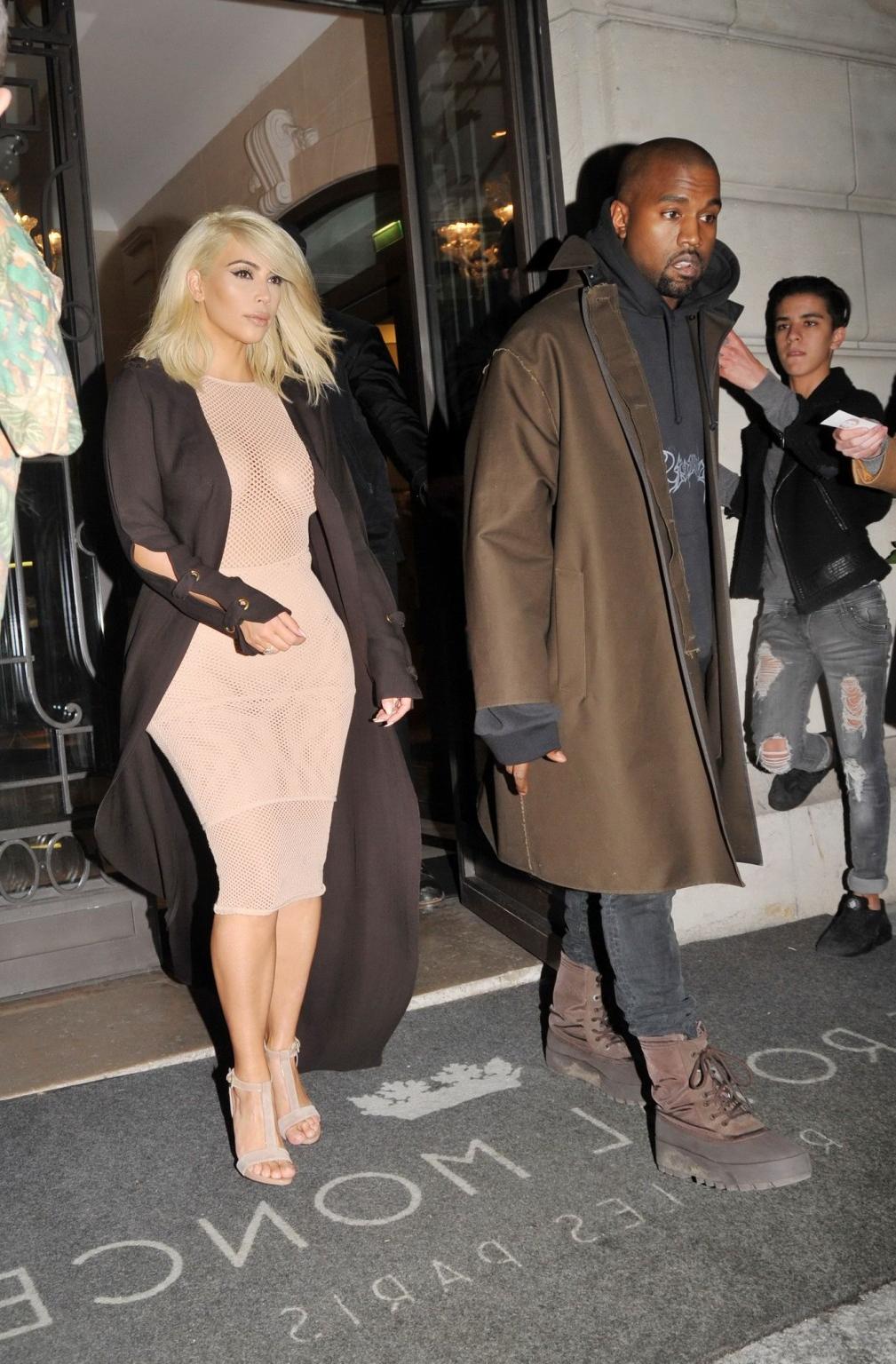 16P Kim Kardashian shows off her huge boobs braless in a fishnet dress at the Lanvin