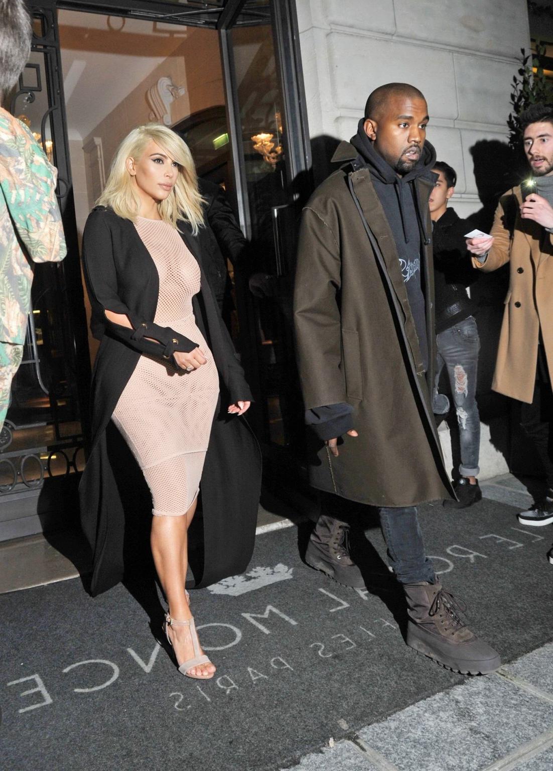 16P Kim Kardashian shows off her huge boobs braless in a fishnet dress at the Lanvin