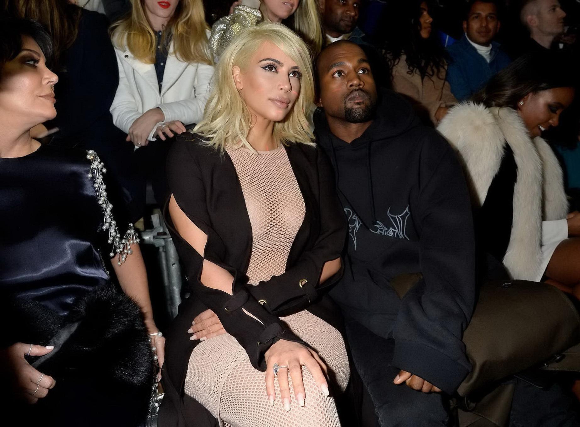 16P Kim Kardashian shows off her huge boobs braless in a fishnet dress at the Lanvin