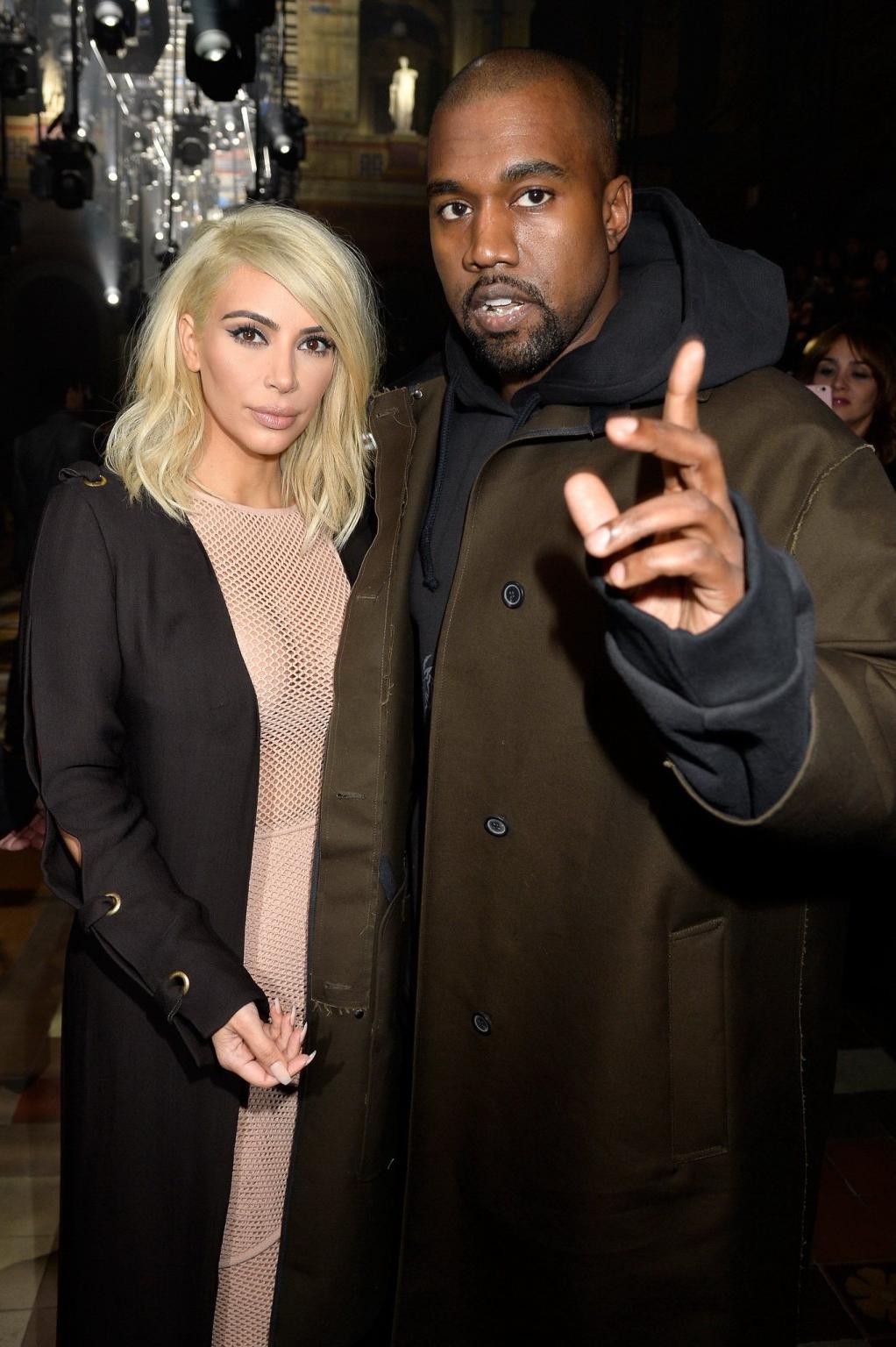 16P Kim Kardashian shows off her huge boobs braless in a fishnet dress at the Lanvin