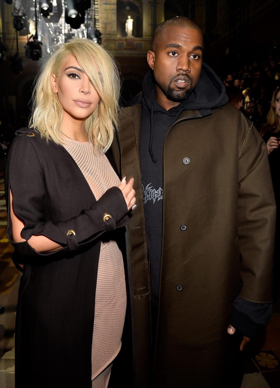 16P Kim Kardashian shows off her huge boobs braless in a fishnet dress at the Lanvin