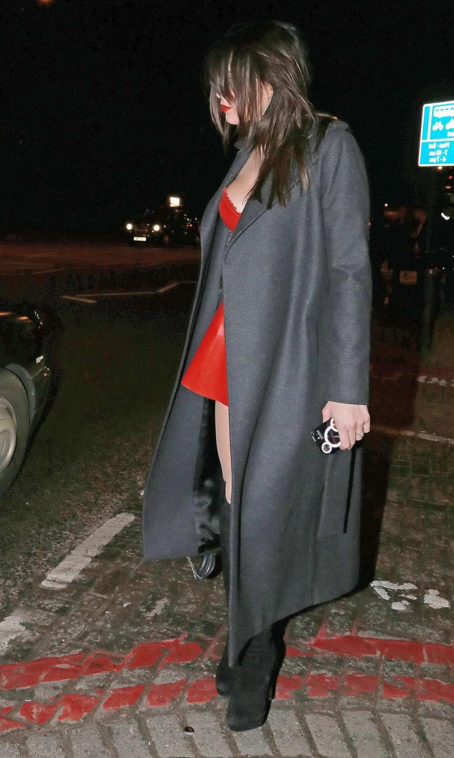 16P Busty Daisy Lowe wears red latex mini dress fishnets  fuckme boots leaving the W