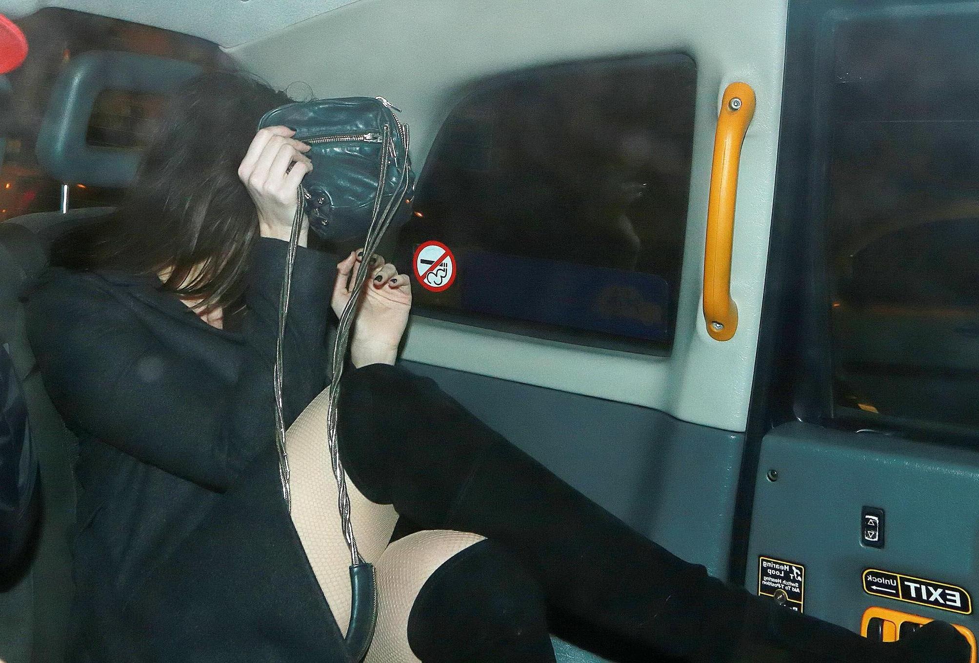 16P Busty Daisy Lowe wears red latex mini dress fishnets  fuckme boots leaving the W