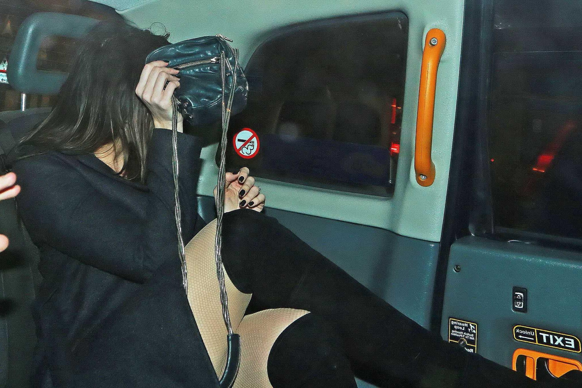 16P Busty Daisy Lowe wears red latex mini dress fishnets  fuckme boots leaving the W