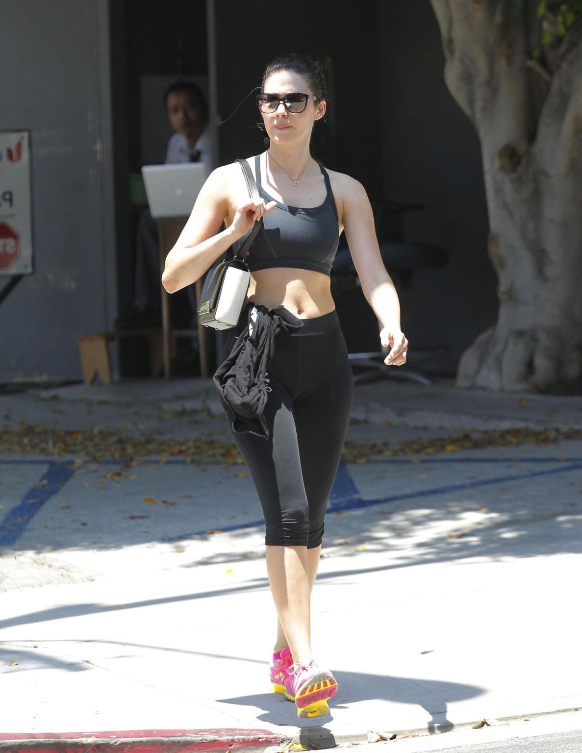 16P Emmy Rossum shows pokies in a black sports bra leaving a gym in Beverly Hills