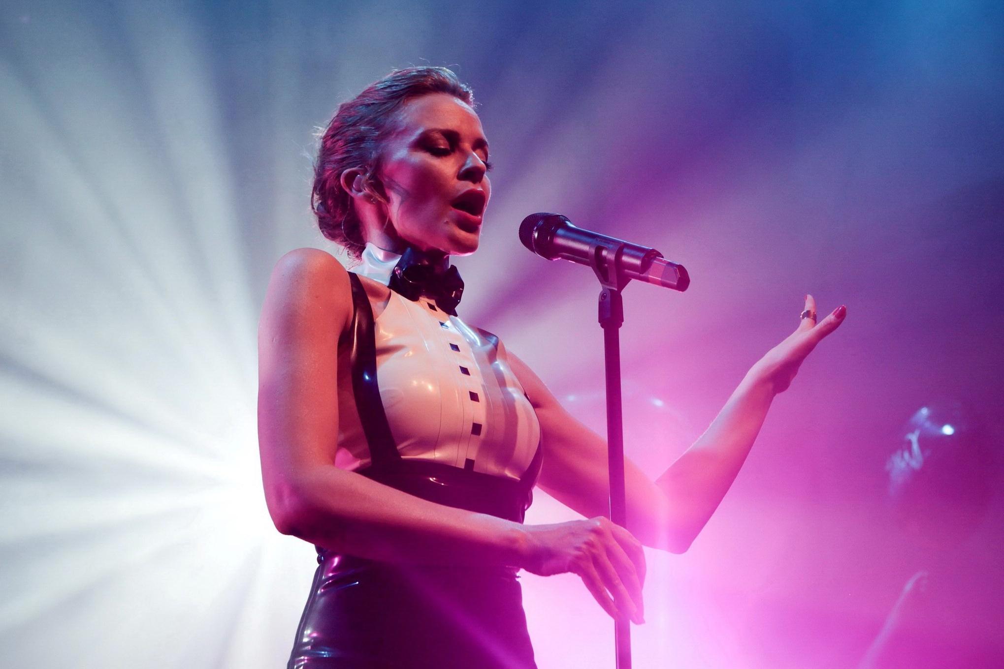 16P Kylie Minogue in tight latex dress performing on stage in Paris