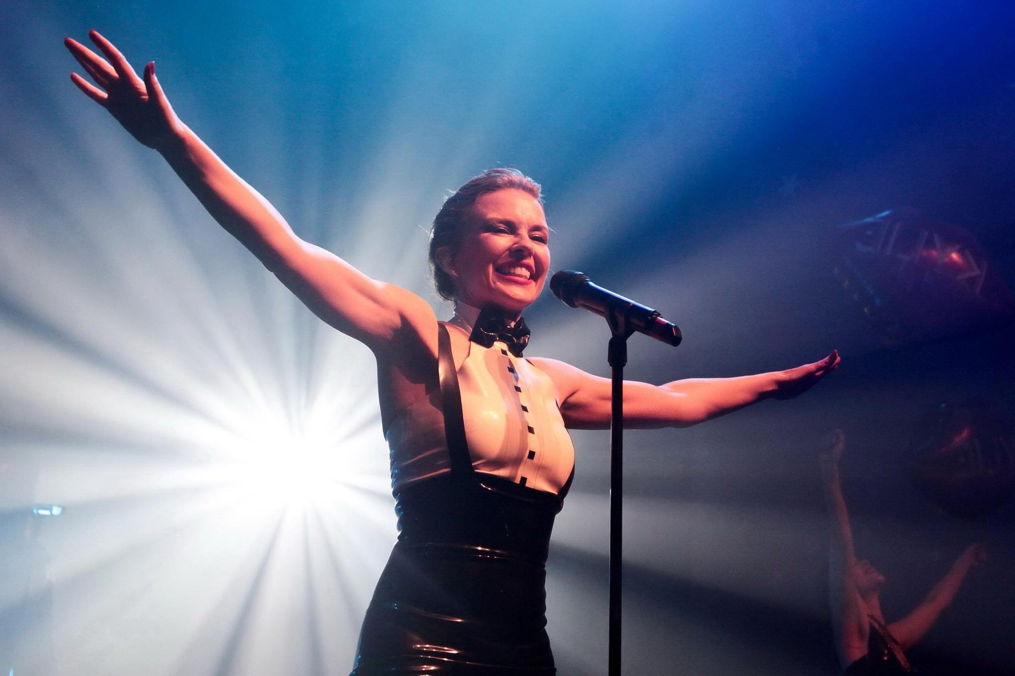16P Kylie Minogue in tight latex dress performing on stage in Paris