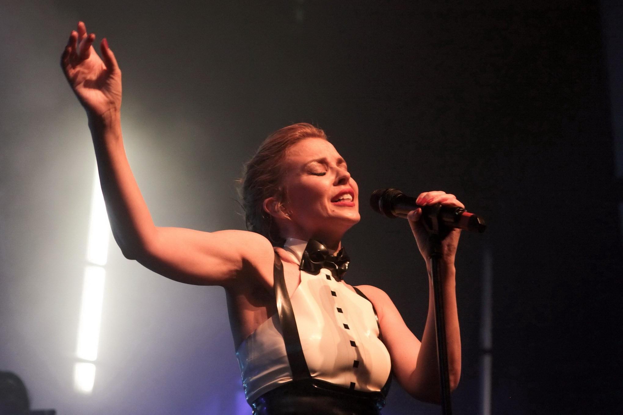 16P Kylie Minogue in tight latex dress performing on stage in Paris