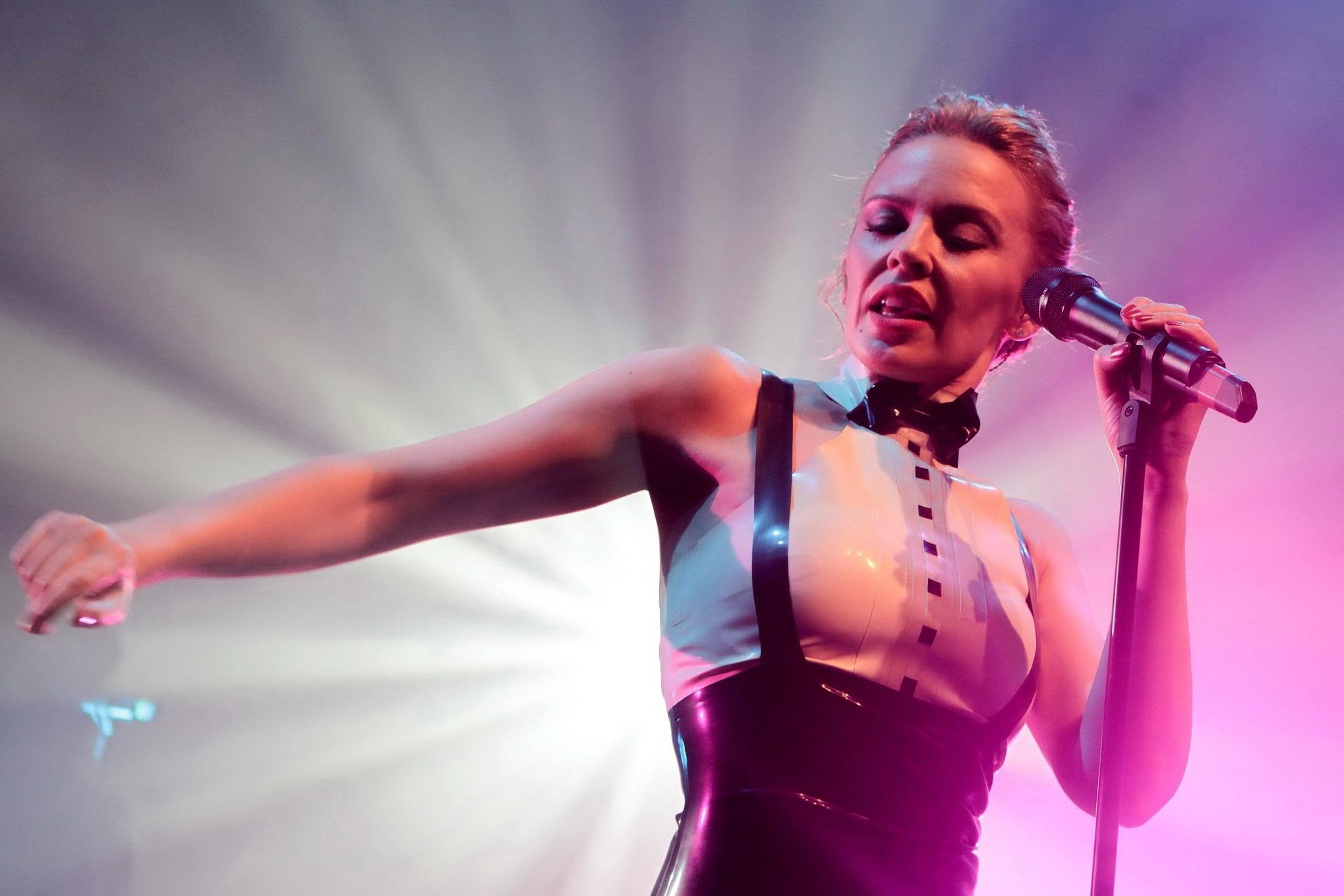 16P Kylie Minogue in tight latex dress performing on stage in Paris