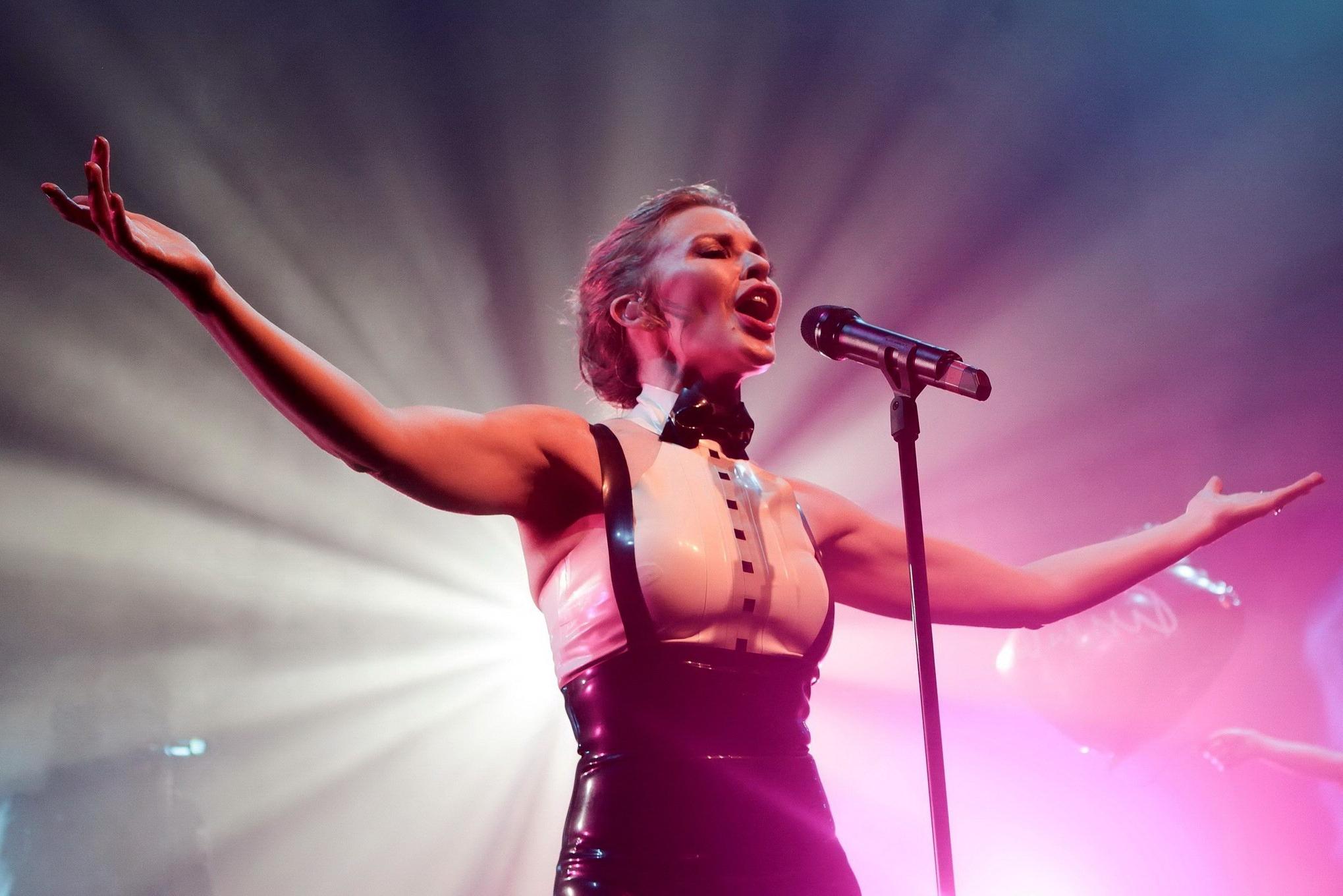 16P Kylie Minogue in tight latex dress performing on stage in Paris